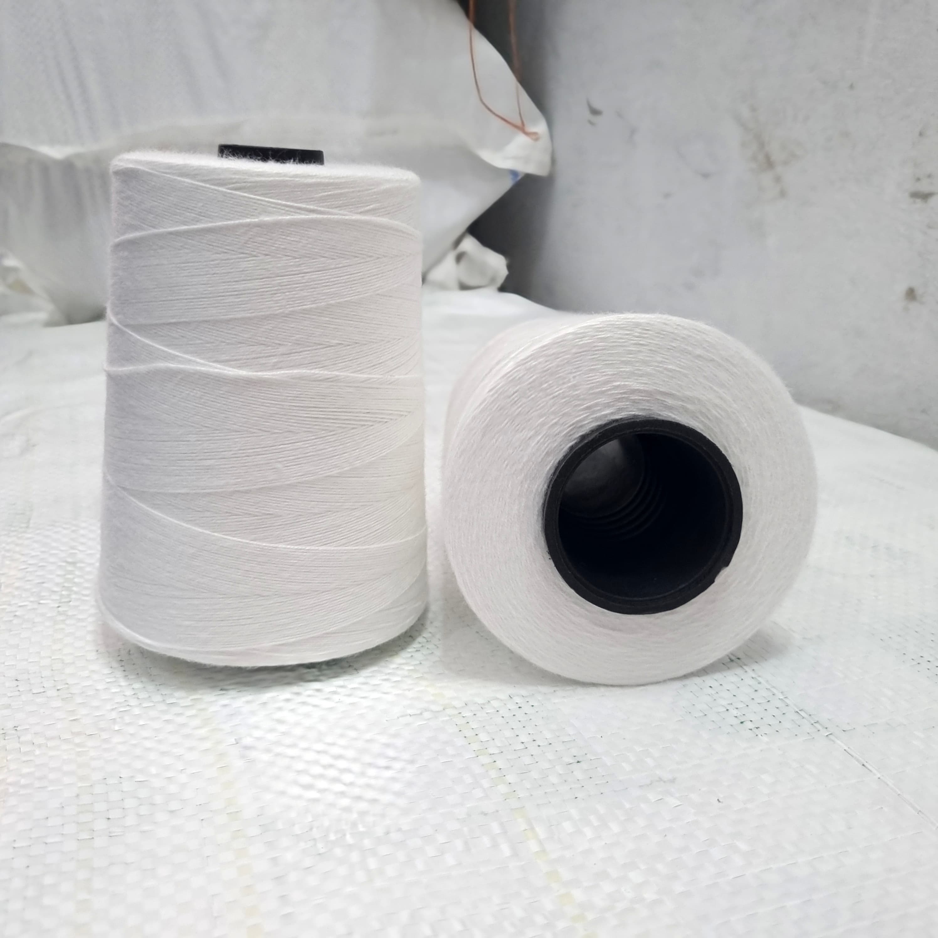 Spools of recycled white polyester yarn