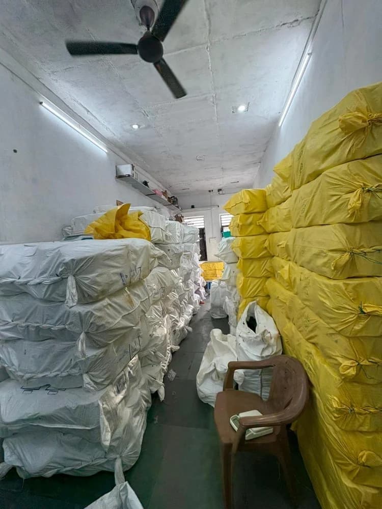 Warehouse aisle with stacked packed yarn stock