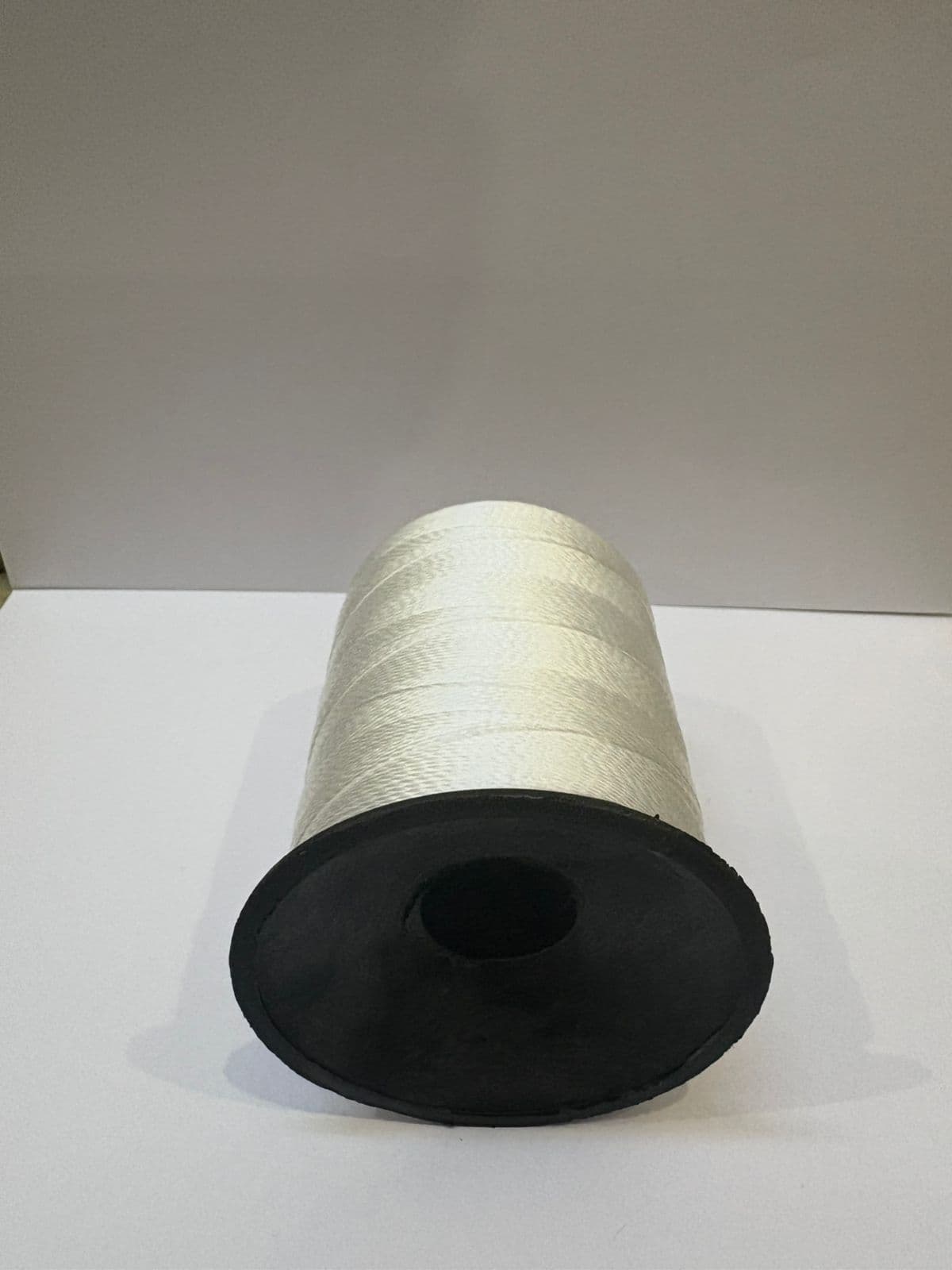 Polypropylene bag closing thread cone, angled view